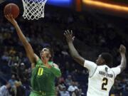 Oregon's Troy Brown, left, lays up a shot in front of California's Juhwan Harris-Dyson (2) in the second half of an NCAA college basketball game Thursday, Feb. 1, 2018, in Berkeley, Calif.