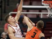 Stanford forward Reid Travis, left, shoots over Oregon State forward Tres Tinkle (3) during the first half of an NCAA college basketball game Thursday, Feb. 1, 2018, in Stanford, Calif.