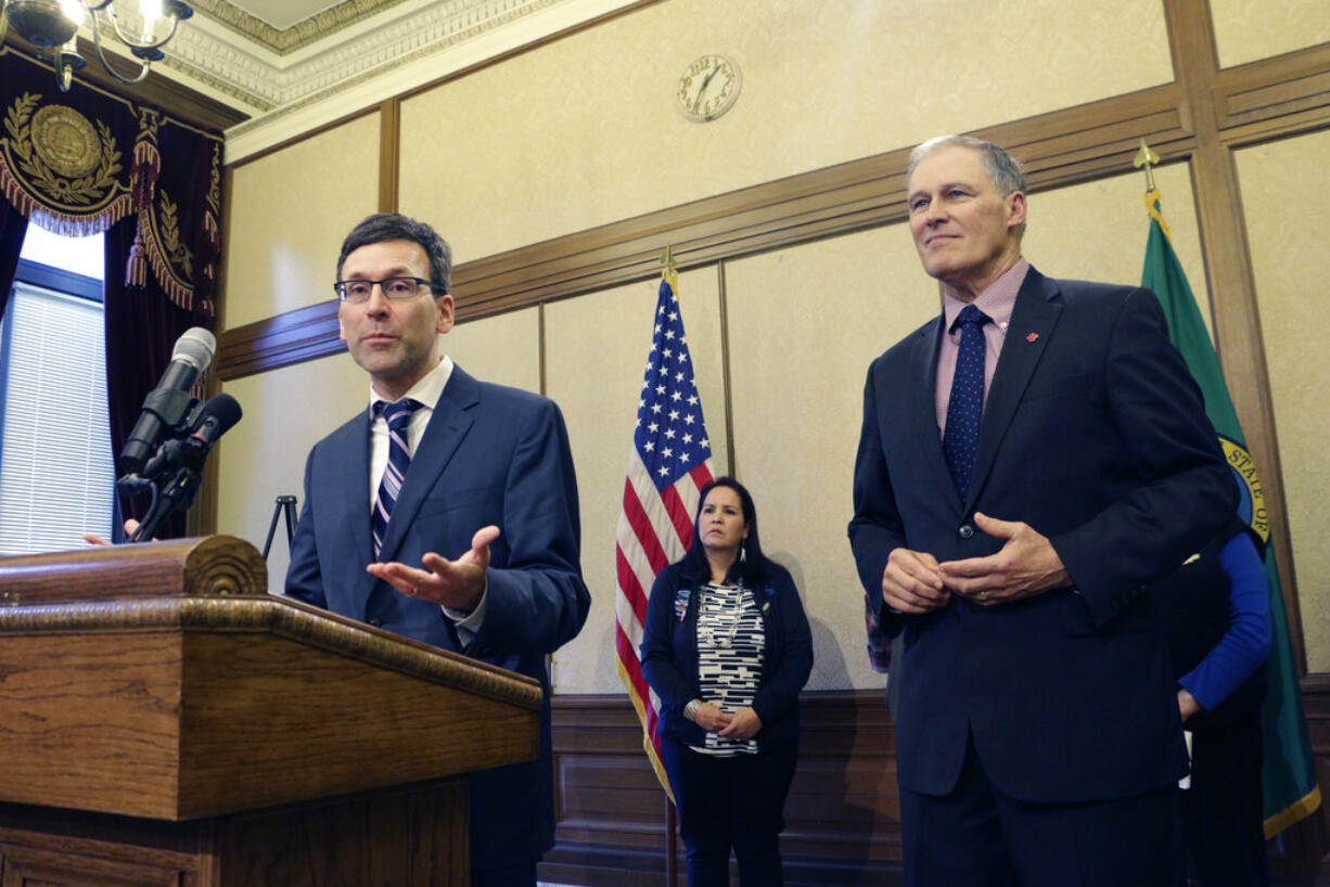 Washington Attorney General Bob Ferguson, left, speaks to the media about the state's opposition to the Trump administration's proposal to expand offshore drilling, as Gov. Jay Inslee looks on, Monday, Feb. 5, 2018, in Olympia, Wash. Ferguson has said he will sue if the state is not exempted from the plan.