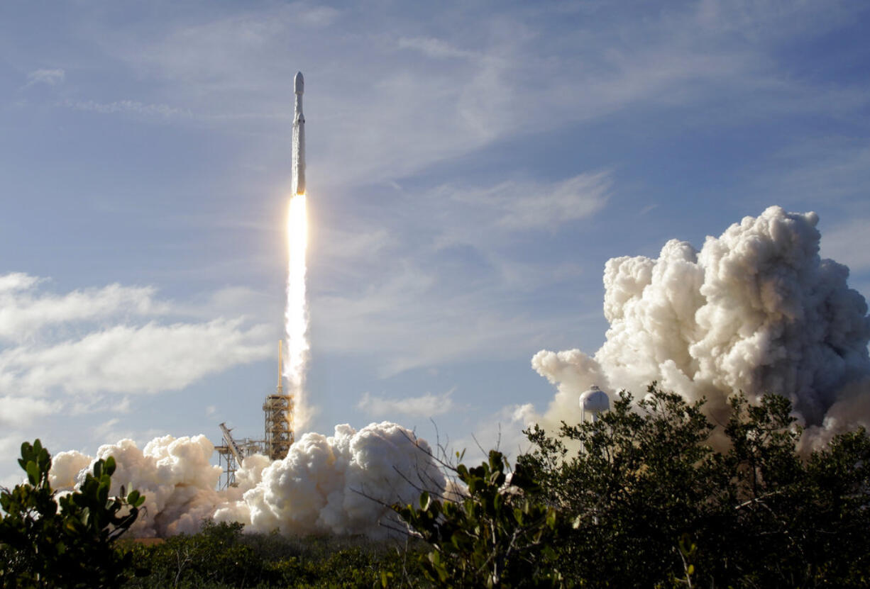 A Falcon 9 SpaceX heavy rocket lifts off from pad 39A at the Kennedy Space Center in Cape Canaveral, Fla., Tuesday, Feb. 6, 2018. The Falcon Heavy, has three first-stage boosters, strapped together with 27 engines in all.