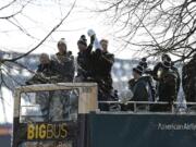 Philadelphia Eagles NFL football head coach Doug Pederson holds up the Vince Lombardi trophy during the Super Bowl LII victory parade, Thursday, Feb 8, 2018, in Philadelphia. From left are Eagles owner Jeffrey Lurie, quarterbacks Nick Foles and Carson Wentz and coach Pederson.