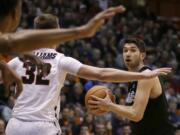 Gonzaga forward Killian Tillie, right, looks to pass against Pacific forward Jack Williams during the first half of an NCAA college basketball game Thursday, Feb. 8, 2018, in Stockton, Calif.