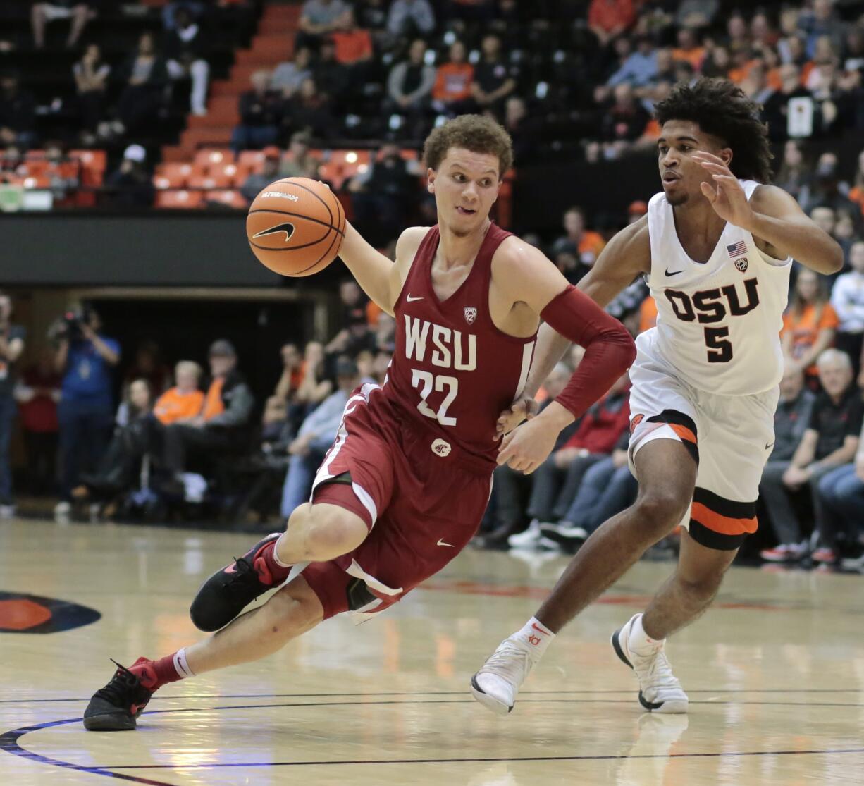 Washington State's Malachi Flynn (22) tries to drive past Oregon State's Ethan Thompson (5) in the first half of an NCAA college basketball game in Corvallis, Ore., Thursday, Feb. 8, 2018. (AP Photo/Timothy J.