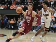 Washington State's Malachi Flynn (22) tries to drive past Oregon State's Ethan Thompson (5) in the first half of an NCAA college basketball game in Corvallis, Ore., Thursday, Feb. 8, 2018. (AP Photo/Timothy J.