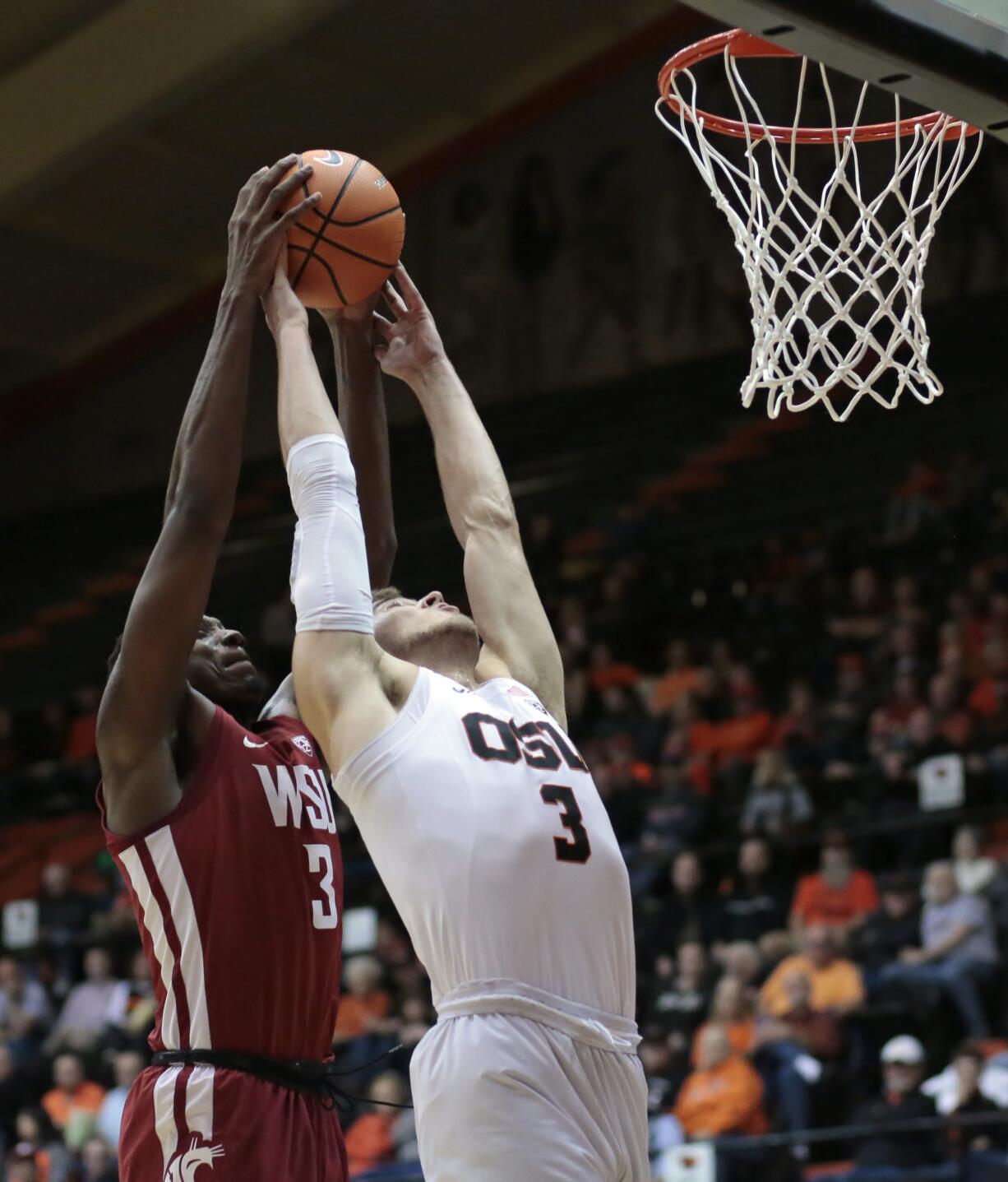 Washington State's Robert Franks, left, goes over Oregon State's Tres Tinkle, right, for a rebound in the first half of an NCAA college basketball game in Corvallis, Ore., Thursday, Feb. 8, 2018. (AP Photo/Timothy J.