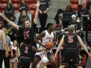 Washington State forward Robert Franks, second from left, spins through the defense of Utah's Parker Van Dyke (5), Justin Bibbins (1) and David Collette (13) as he drives to the basket during the first half of an NCAA college basketball game Saturday, Feb. 17, 2018, in Pullman, Wash. (AP Photo/Ted S.