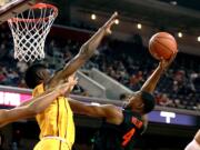 Oregon State forward Alfred Hollins, right, shoots under pressure from Southern California forward Chimezie Metu during the first half of an NCAA college basketball game Saturday, Feb. 17, 2018, in Los Angeles. (AP Photo/Ringo H.W.