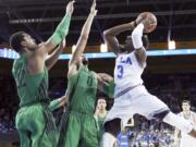 UCLA guard Aaron Holiday (3) shoots as Oregon forwards Mikyle McIntosh (22) and Troy Brown (0) defend during overtime in an NCAA college basketball game in Los Angeles Saturday, Feb. 17, 2018. UCLA won 86-78.