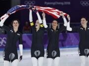 Bronze medalist team U.S.A. with Heather Bergsma, right, Brittany Bowe, second right, Mia Manganello, second left, and Carlijn Schoutens, left, celebrates after the women's team pursuit final speedskating race at the Gangneung Oval at the 2018 Winter Olympics in Gangneung, South Korea, Wednesday, Feb. 21, 2018.