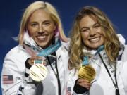 Gold medalists in the women's team sprint freestyle cross-country skiing Kikkan Randall and Jessica Diggins, of the United States, pose during the medals ceremony at the 2018 Winter Olympics in Pyeongchang, South Korea, Thursday, Feb. 22, 2018.