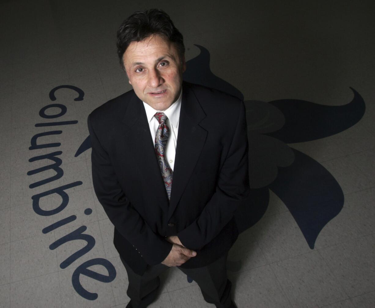 FILE- This March 31, 2006 file photo shows Columbine High School Principal Frank DeAngelis standing in the entry of the school in Littleton, Colo.  Following school shootings like the massacre at Marjory Stoneman Douglas High, administrators reach out to the former Columbine High principal  as there is no book to teach what he learned after gunmen killed 12 of his students and a teacher in 1999.