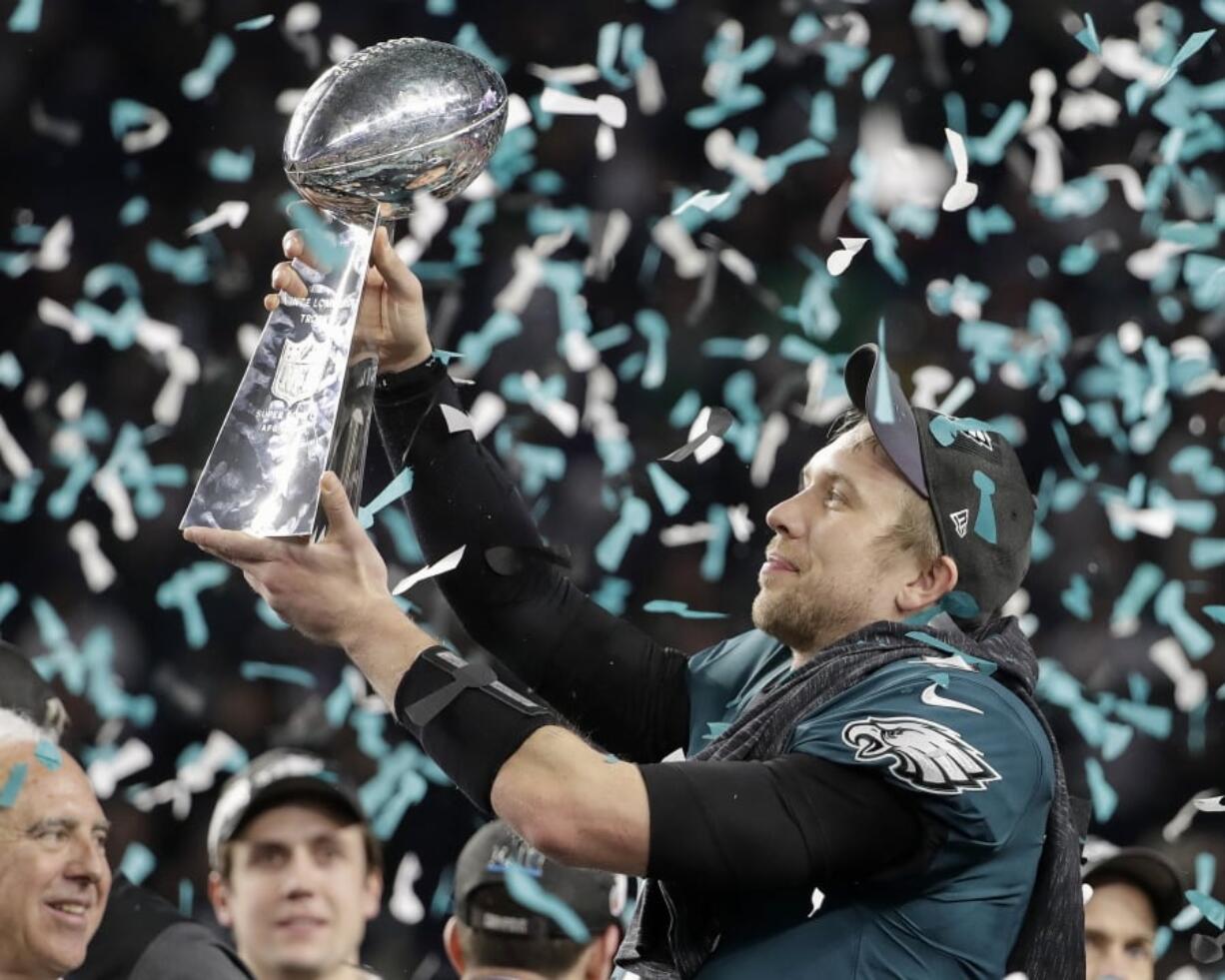 Philadelphia Eagles’ Nick Foles holds up the Vince Lombardi Trophy after the NFL Super Bowl 52 football game against the New England Patriots, Sunday, Feb. 4, 2018, in Minneapolis. The Eagles won 41-33.