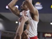 Gonzaga forward Johnathan Williams, top, grabs a rebound over BYU guard Jahshire Hardnett during the first half of an NCAA college basketball game in Spokane, Wash., Saturday, Feb. 3, 2018.