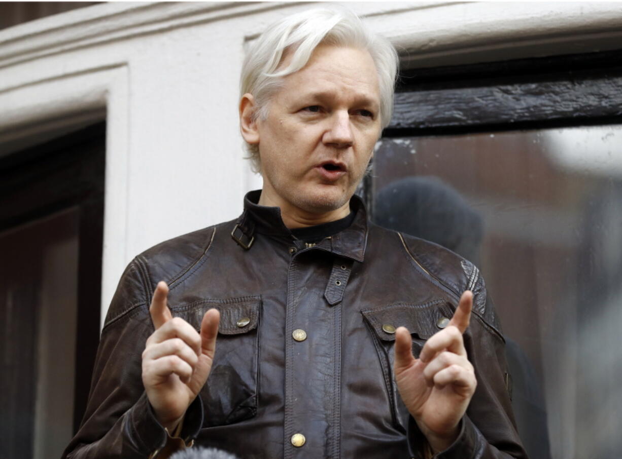 WikiLeaks founder Julian Assange gestures May 19 to supporters outside the Ecuadorian embassy in London, where he has been in self imposed exile since 2012. A British judge on Tuesday, 20-18 is scheduled to quash or uphold an arrest warrant for WikiLeaks founder Julian Assange, who has spent more than five years inside Ecuador’s London embassy.