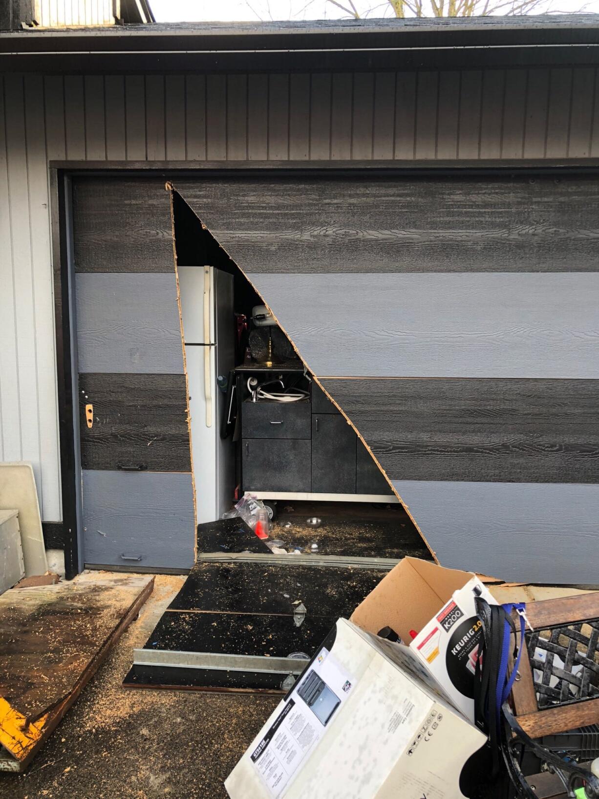 Camas-Washougal firefighters cut the garage door of this Camas home with a chainsaw in order to free a 70-year-old man trapped inside during a response on Wednesday afternoon. Authorities did not release the man's name and said in a Thursday update that his current condition is unknown.