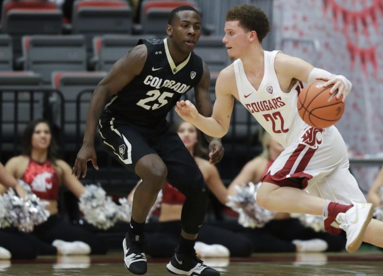 Washington State guard Malachi Flynn (22) drives past Colorado guard McKinley Wright IV (25) during the second half of an NCAA college basketball game Thursday, Feb. 15, 2018, in Pullman, Wash. Washington State won 73-69. (AP Photo/Ted S.