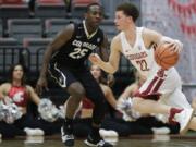 Washington State guard Malachi Flynn (22) drives past Colorado guard McKinley Wright IV (25) during the second half of an NCAA college basketball game Thursday, Feb. 15, 2018, in Pullman, Wash. Washington State won 73-69. (AP Photo/Ted S.