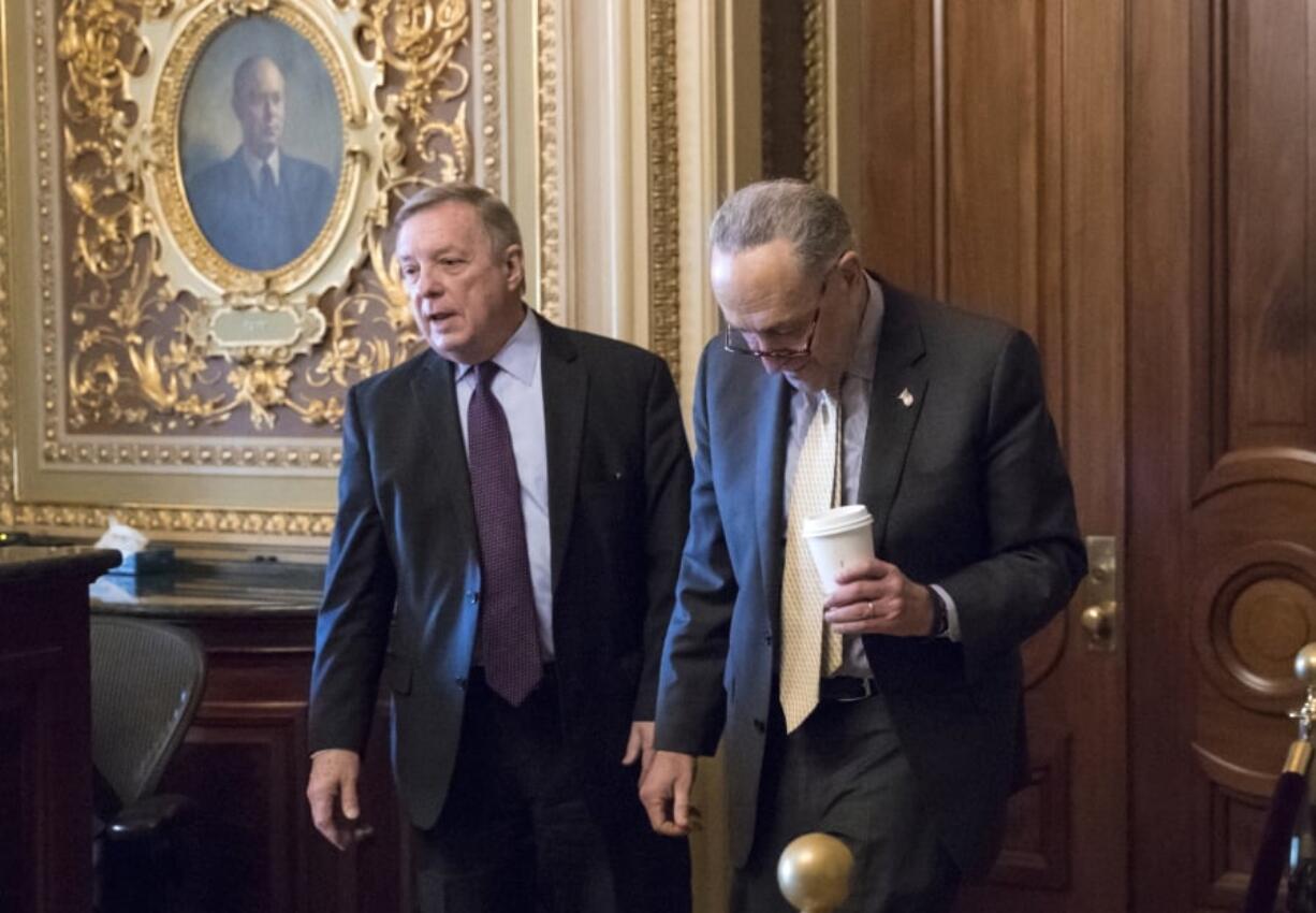 Sen. Dick Durbin, D-Ill., left, and Senate Minority Leader Chuck Schumer, D-N.Y., walk together outside the chamber during debate in the Senate on immigration, at the Capitol in Washington, Wednesday. Schumer said on the Senate floor that “the one person who seems most intent on not getting a deal is President Trump.” (AP Photo/J.