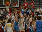 Columbia River guard Nate Snook contests a shot from a Mark Morris guard during a 50-49 loss to the Monarchs in the 2A district championship game at St. Martin's University on Friday, Feb.