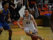 Union guard Ethan Smith drives to the basket in the fourth quarter of the Titans' 75-65 overtime loss to Federal Way in the 4A state tournament on Saturday, Feb.