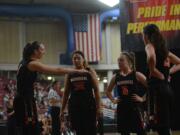 Washougal's Beyonce Bea (5) game-plans with Tiana Barnett (3), Kiara Cross (0) and Skylar Bea (25) during a break in play in the Panthers' 55-46 loss to Lynden on Wednesday, Feb.