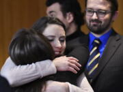 Rachael Denhollander hugs Det. Lt. Andrea Munford on Monday after the third and final day of sentencing in Eaton County Court in Charlotte, Mich., where Nassar was sentenced on three counts of sexual assault.