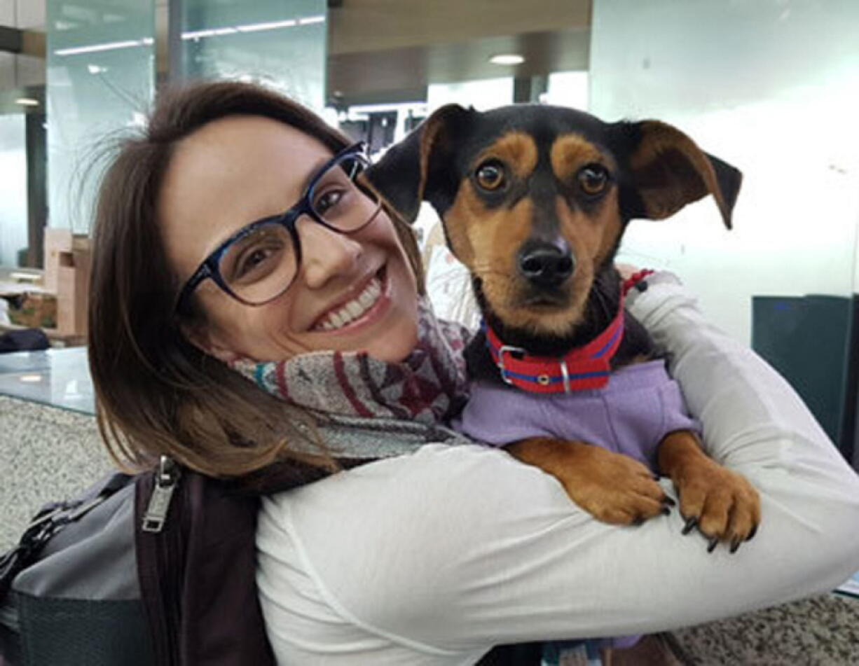In this undated photo provided by Free Korean Dogs, Canadian figure skater Meagan Duhamel poses with her dog Moo-tae, right, in South Korea. Duhamel already has one life-changing souvenir from South Korea, and it’s not a medal. The Olympic pairs skater rescued a puppy from the Korean dog meat trade while competing in Pyeongchang last year, and she’s helping organize more adoptions while skating there at this year’s games.