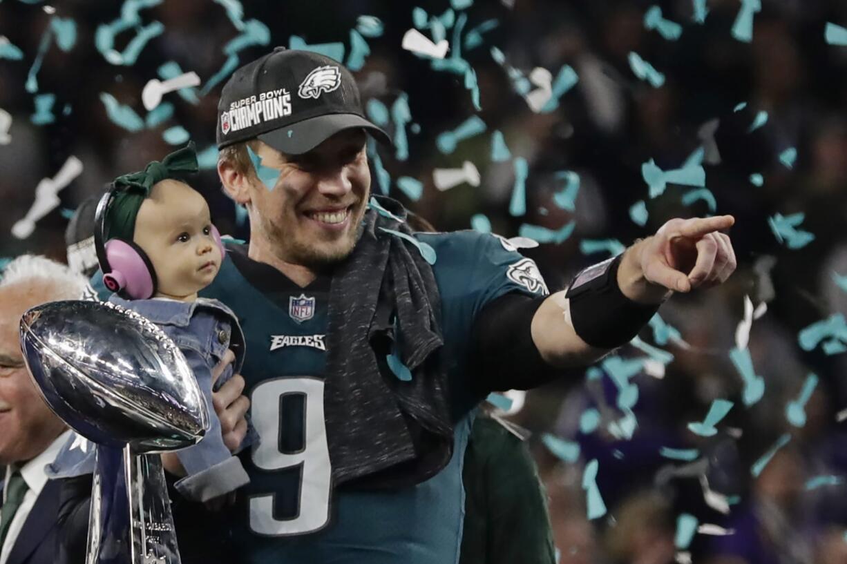 Philadelphia Eagles quarterback Nick Foles (9) holds his daughter, Lily James, after winning the NFL Super Bowl 52 football game against the New England Patriots, Sunday, Feb. 4, 2018, in Minneapolis. The Eagles won 41-33.