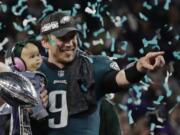 Philadelphia Eagles quarterback Nick Foles (9) holds his daughter, Lily James, after winning the NFL Super Bowl 52 football game against the New England Patriots, Sunday, Feb. 4, 2018, in Minneapolis. The Eagles won 41-33.