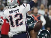 Philadelphia Eagles’ Brandon Graham, center, strips the ball from New England Patriots quarterback Tom Brady during the second half of the NFL Super Bowl 52 football game Sunday, Feb. 4, 2018, in Minneapolis. The Eagles recovered the fumble.