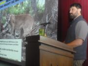 Mountain lion researcher Mark Elbroch gives a presentation Feb. 1 on cougar interactions during a Studium Generale lecture at Peninsula College in Port Angelesh. After a 17-year study of the animals in northwest Wyoming, Elbroch discovered that cougars are far more social than previously thought.