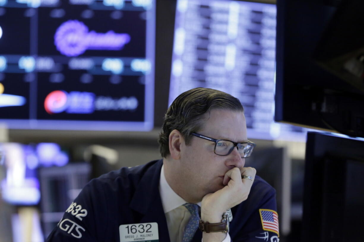 Specialist Gregg Maloney works at his post on the floor of the New York Stock Exchange on Wednesday. Stocks are opening modestly higher on Wall Street as the market stabilizes following three days of tumult.