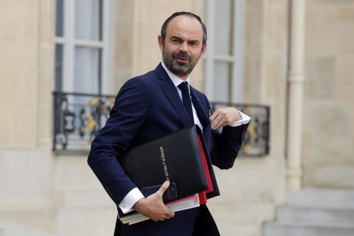 French Prime Minister Edouard Philippe leaves after the weekly cabinet meeting at the Elysee Palace in Paris. France unveiled Friday, Feb. 23 a vast new program to counter radicalization, as jihadis return from the battlefields of Syria and Iraq and the watch list of people showing risk signs grows. The plan, announced by Prime Minister Edouard Philippe, is made up of 60 measures and puts the accent on prevention, notably aimed at digging into the roots of society to catch danger signals.