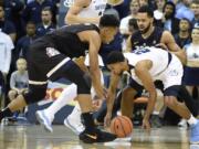 Gonzaga forward Johnathan Williams (3) fights for a loose ball with San Diego guard Isaiah Wright (22) during the first half of an NCAA college basketball game Thursday, Feb. 22, 2018, in San Diego.