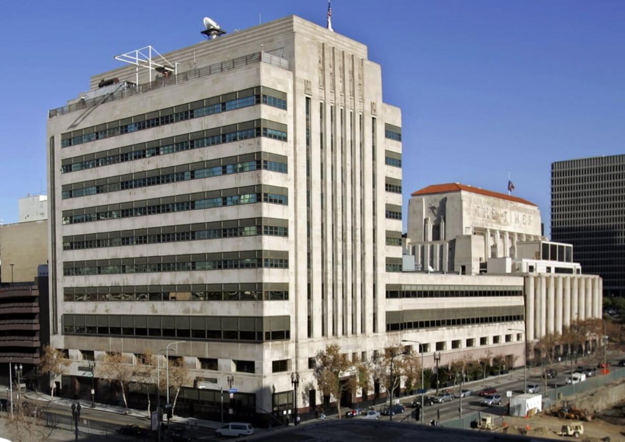 FILE - This Jan. 9, 2007, file photo shows the Los Angeles Times buildings in downtown Los Angeles. It was announced Wednesday, Feb. 7, 2018, that the Los Angeles Times is being sold to Dr. Patrick Soon-Shiong, a local billionaire, for $500 million, ending its strained tenure under the owner of the Chicago Tribune. Soon-Shiong is a major shareholder of Chicago's Tronc Inc., one of the richest men in Los Angeles and, according to Forbes, the nation's wealthiest doctor, with a net worth of $7.8 billion.