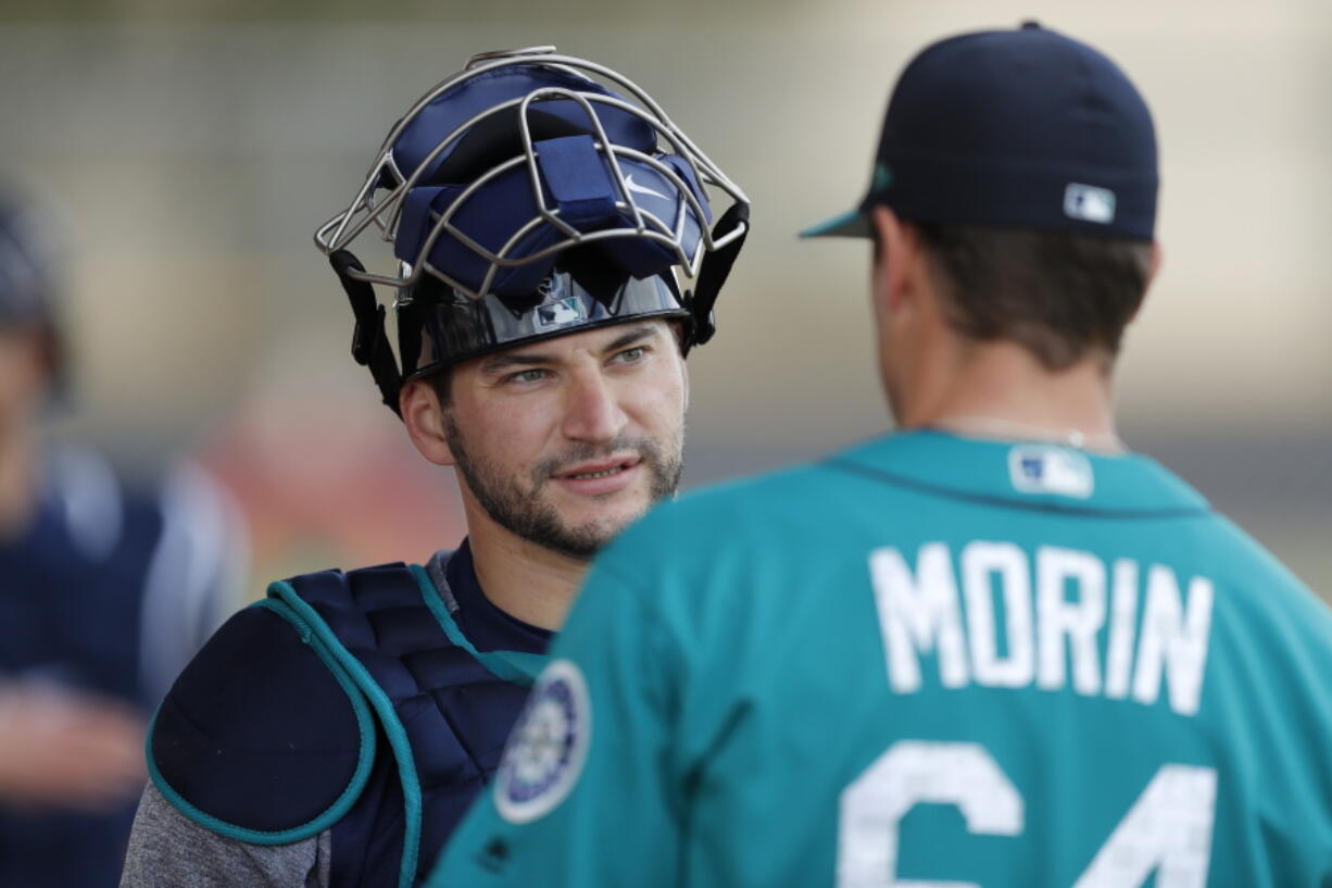 Seattle Mariners catcher Mike Zunino, left, talks with relief pitcher Mike Morin during a baseball workout on Monday.