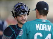 Seattle Mariners catcher Mike Zunino, left, talks with relief pitcher Mike Morin during a baseball workout on Monday.