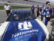 Alex Bowman, right, stands by his car on pit road after he won the pole position during qualifying for the NASCAR Daytona 500 auto race at Daytona International Speedway, Sunday, Feb. 11, 2018, in Daytona Beach, Fla.