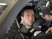 Kurt Busch, left, talks with a crew member before going out on the track during a NASCAR auto racing practice session at Daytona International Speedway, Saturday, Feb. 10, 2018, in Daytona Beach, Fla.