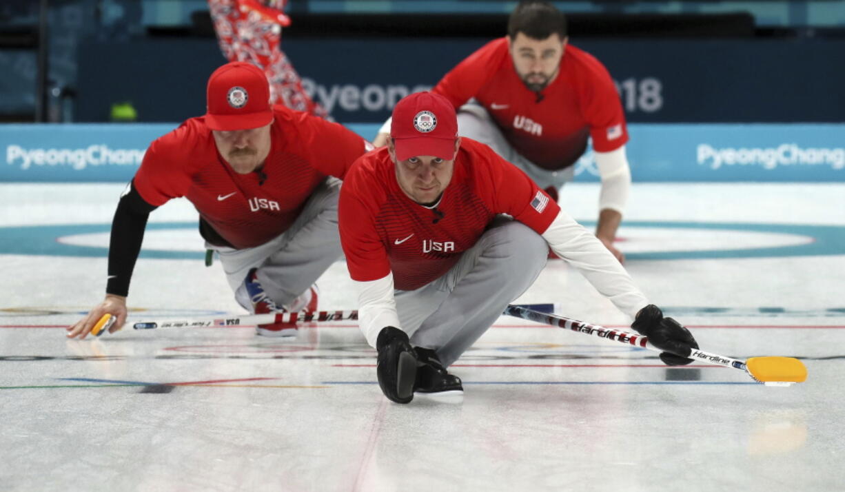 United States’s skip John Shuster, center, slides on the ice with teammates before the start of the their men’s curling match against United States at the 2018 Winter Olympics in Gangneung, South Korea, on Sunday.