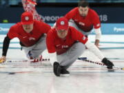 United States’s skip John Shuster, center, slides on the ice with teammates before the start of the their men’s curling match against United States at the 2018 Winter Olympics in Gangneung, South Korea, on Sunday.