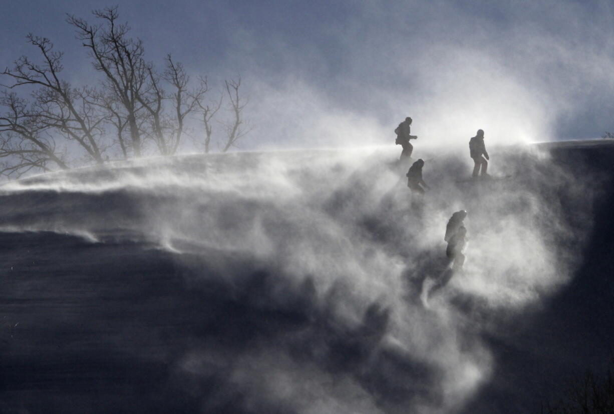 Workers are shrouded in snow after the women’s giant slalom was postponed due to high winds at the 2018 Winter Olympics at the Yongpyong Alpine Center, Pyeongchang, South Korea.