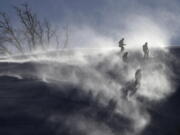 Workers are shrouded in snow after the women’s giant slalom was postponed due to high winds at the 2018 Winter Olympics at the Yongpyong Alpine Center, Pyeongchang, South Korea.