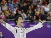 Yuzuru Hanyu of Japan gestures to the crowd as he prepares to stand on the podium after winning the gold medal in the men’s free figure skating final in the Gangneung Ice Arena at the 2018 Winter Olympics in Gangneung, South Korea, Saturday, Feb. 17, 2018. (AP Photo/David J.