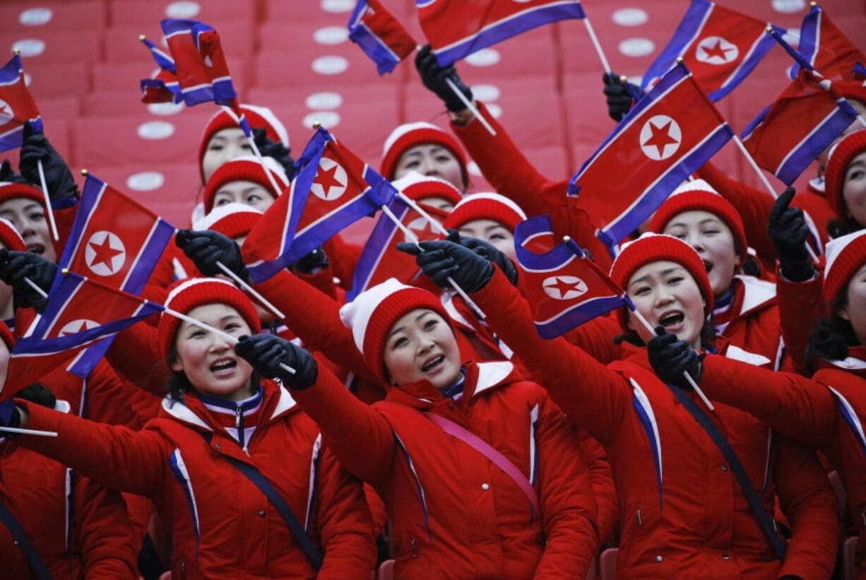 Members of the North Korean delegation wave flags at the women’s slalom at Yongpyong alpine center at the 2018 Winter Olympics in Pyeongchang, South Korea. While in South Korea, the North Koreans wear the same uniforms, move together whenever possible and operate as a tightly knit team.