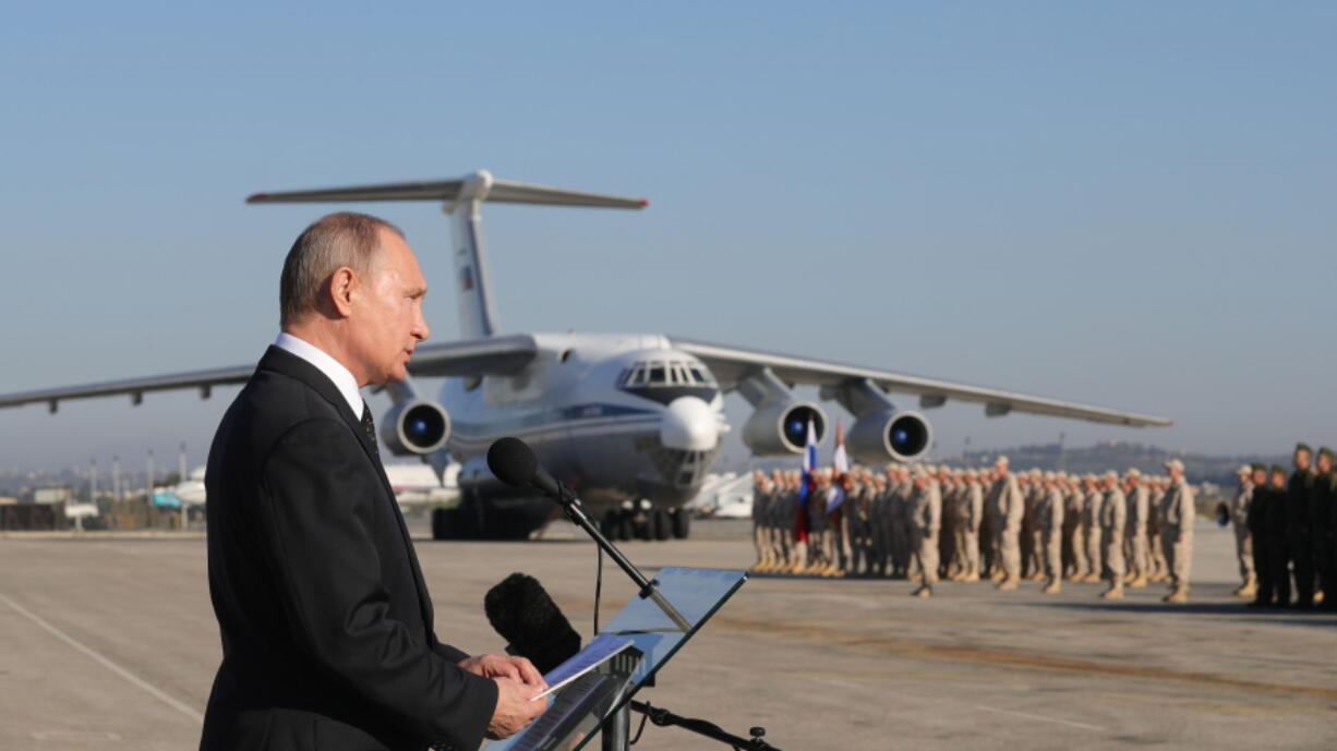 Russian President Vladimir Putin addresses the troops Dec. 12 at the Hemeimeem air base in Syria. Several private Russian military contractors were killed by a U.S. strike in Syria, Russian media reported Tuesday in a development that could further inflame Russia-U.S. tensions if officially confirmed.