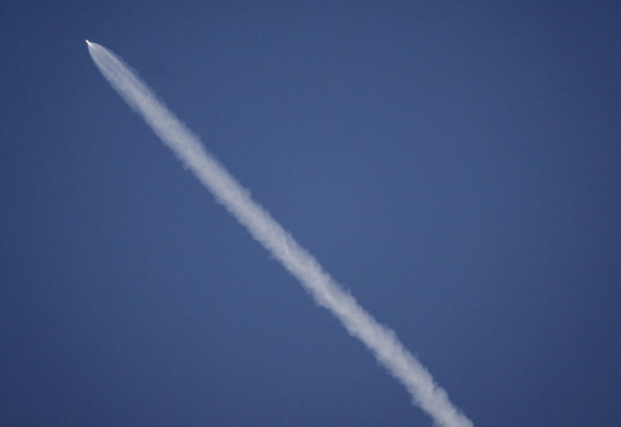 A SpaceX rocket carrying a Spanish satellite is seen over the sky in Los Angeles on Thursday. The rocket created a brief light show over Southern California after blasting off from Vandenberg Air Force Base. The Falcon 9 rose above coastal clouds into the dawn sky Thursday and arced southward over the Pacific Ocean west of Los Angeles.