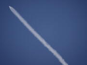 A SpaceX rocket carrying a Spanish satellite is seen over the sky in Los Angeles on Thursday. The rocket created a brief light show over Southern California after blasting off from Vandenberg Air Force Base. The Falcon 9 rose above coastal clouds into the dawn sky Thursday and arced southward over the Pacific Ocean west of Los Angeles.