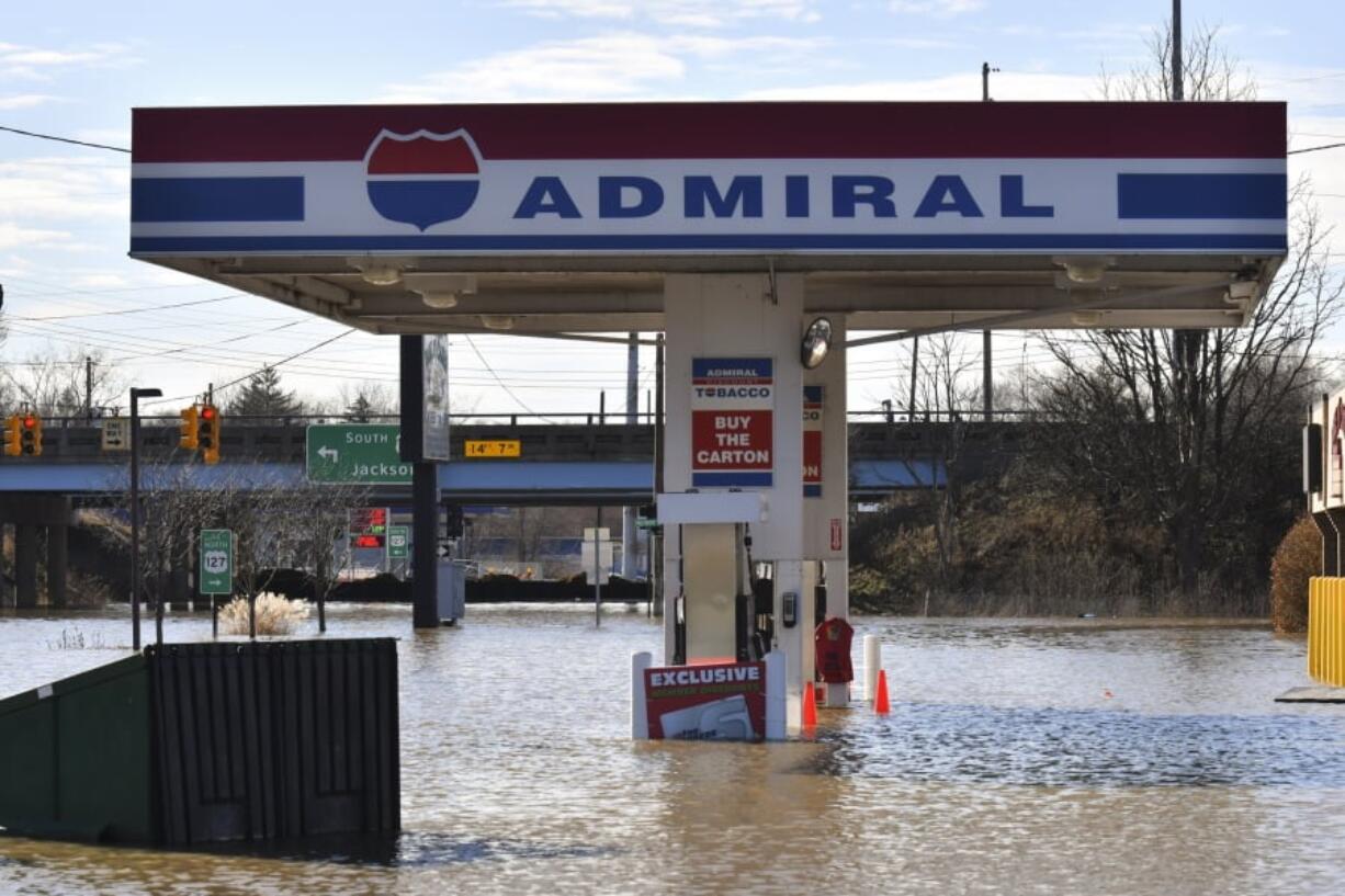 The Admiral gas station is under water from flooding Thursday in Lansing, Mich. Flooding is expected to continue through the weekend in Michigan, Indiana and other Midwest states that have been swamped by high water from heavy rains and melting snow.