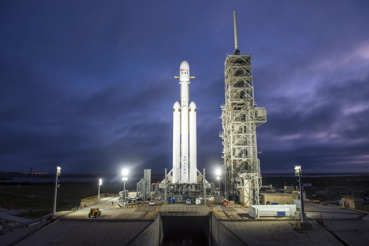 A Falcon Heavy rocket is seen Dec. 28 in Cape Canaveral, Fla. With more than 5 million pounds of liftoff thrust the Heavy will be capable of lifting super-size satellites into orbit and sending spacecraft to the moon, Mars and beyond.